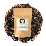 organic apple cinnamon decaf tea with visible brand label surrounded by loose tea leaves on a white background