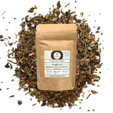 Truly Tea package surrounded by tea leaves on a white background