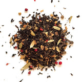 Spice mix including cardamom, cinnamon, and cloves on a white background